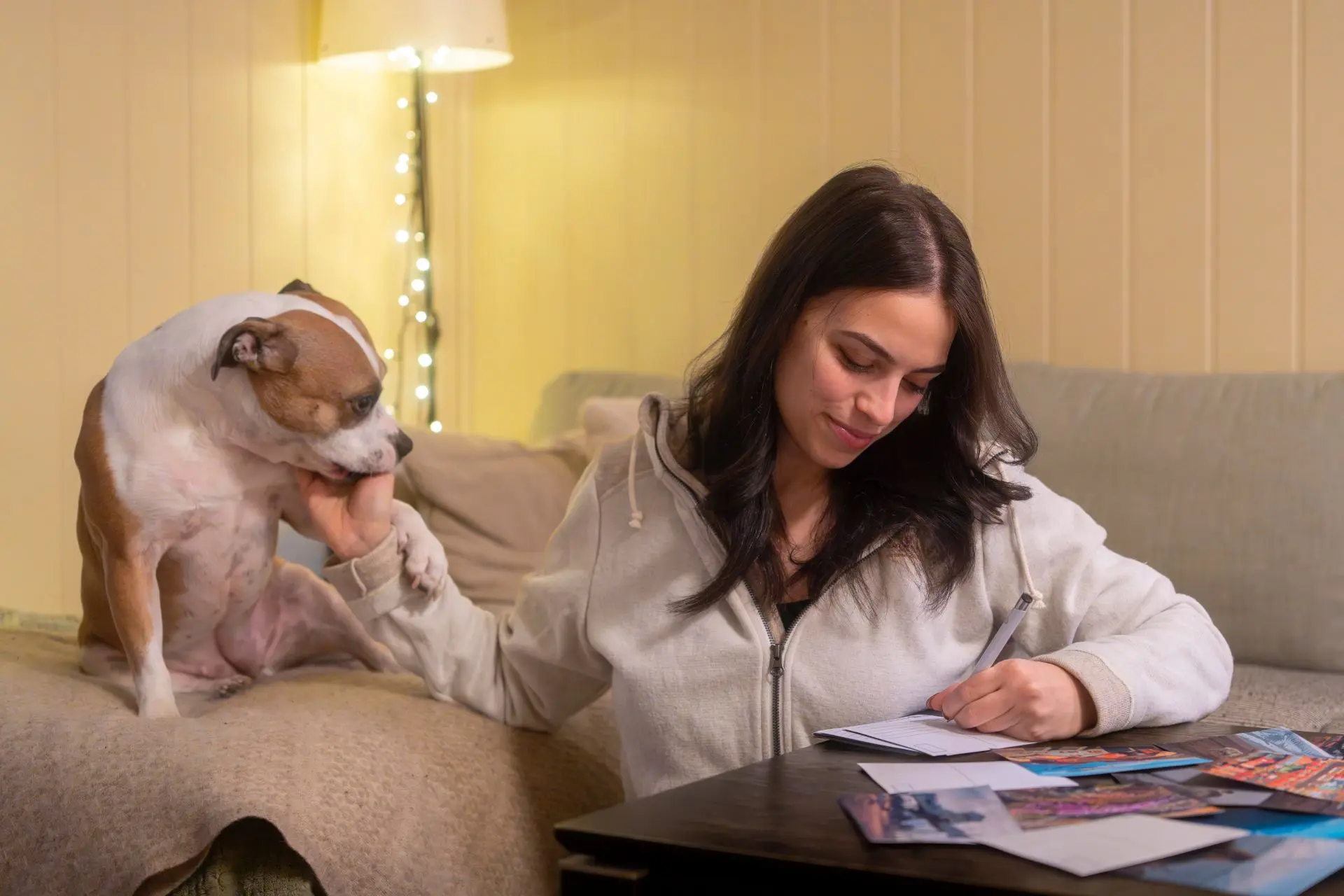 Giulia relaxing on the sofa with her dog
